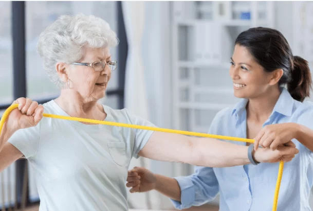 senior woman with physical therapist