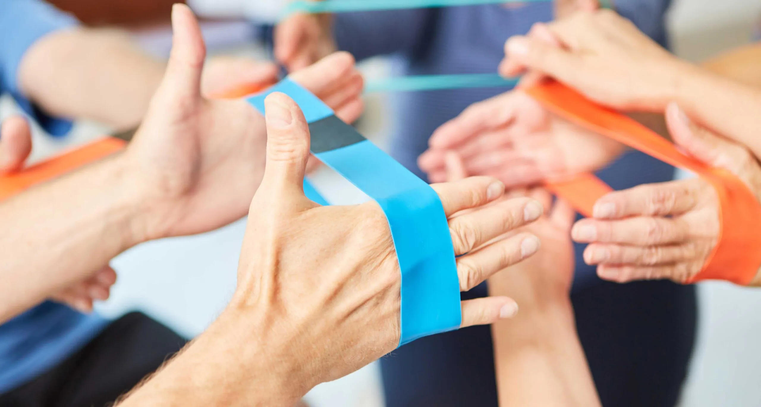 Hands do exercise with the elastic band as physiotherapy in rehab